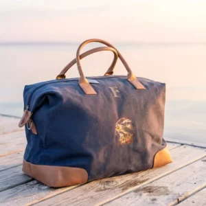 maleta personalizada con logo o iniciales de lona y piel, con halcón bordado